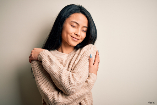 woman smiling with hand on cheek