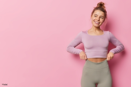 woman smiling with hand on waist