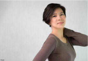 woman touching the back of her neck